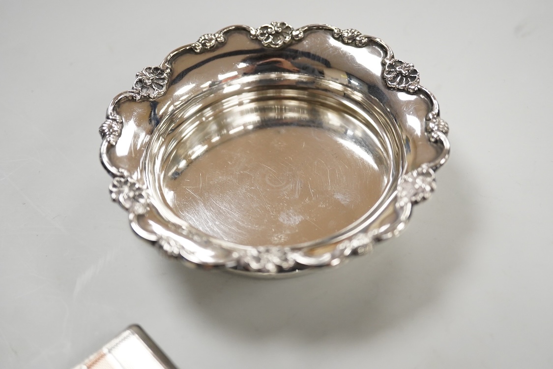 A George V silver pedestal bon bon dish, Sheffield, 1921, diameter 13.2cm, one other earlier silver dish by Josiah Williams & Co, London, 1904 and a silver cigarette case. and a cigarette case, gross 11.5oz.